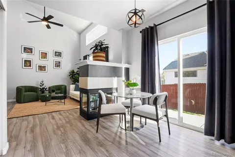 a living room with furniture a flat screen tv and a large window