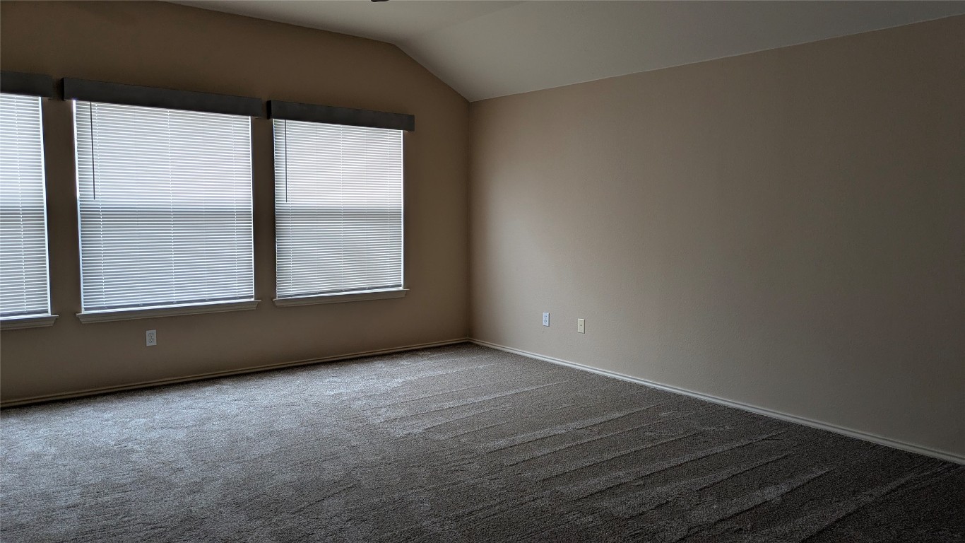 833 Rusk Road Round Rock, TX 78665 - Photo 11 of 15 an empty room with wooden floor and windows