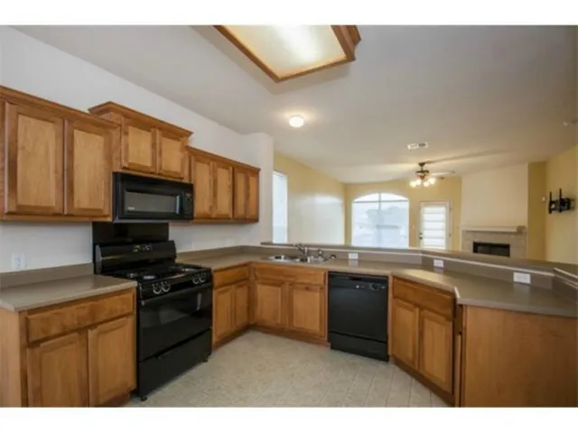 a kitchen with stainless steel appliances granite countertop a stove sink microwave and cabinets