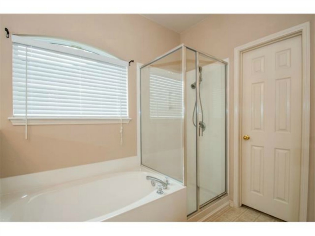 833 Rusk Road Round Rock, TX 78665 - Photo 8 of 15 a bathroom with a shower and a bath tub