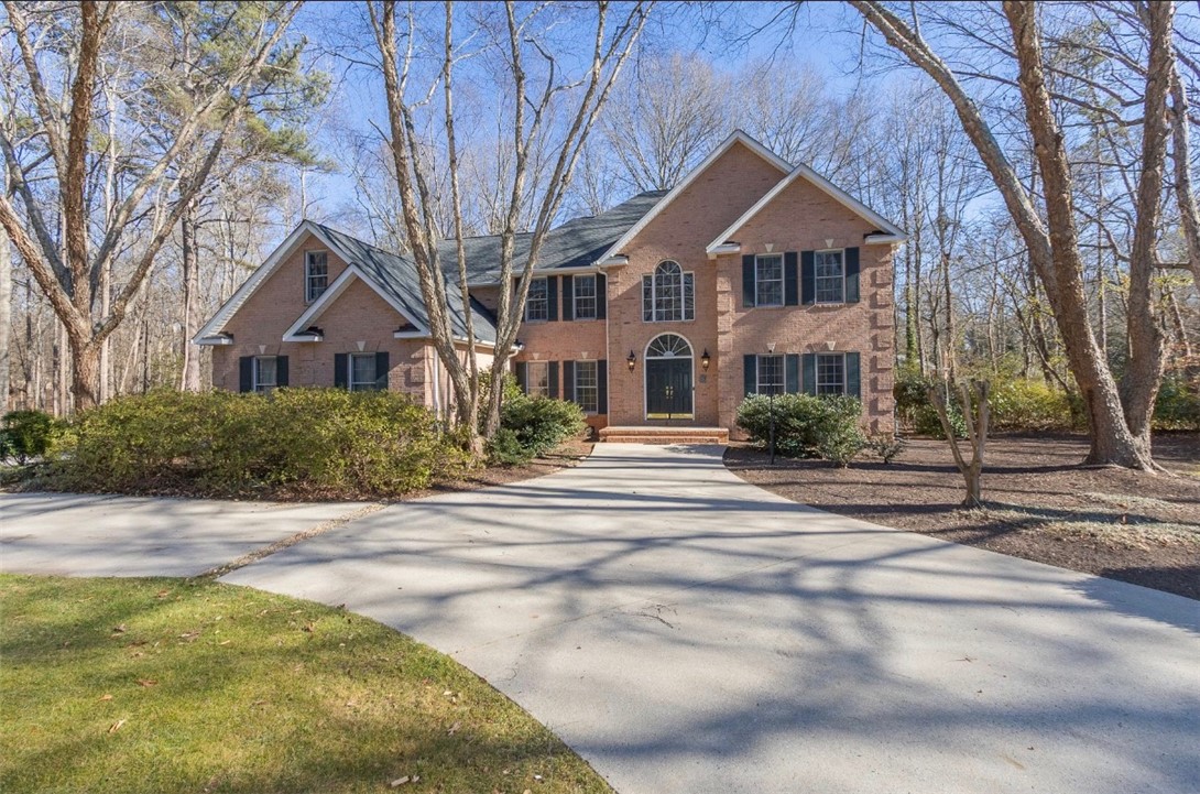 1104 Thornehill Drive Anderson, SC 29621 - Photo 2 of 35 This classic brick residence features an inviting facade and a sweeping driveway amidst mature trees.