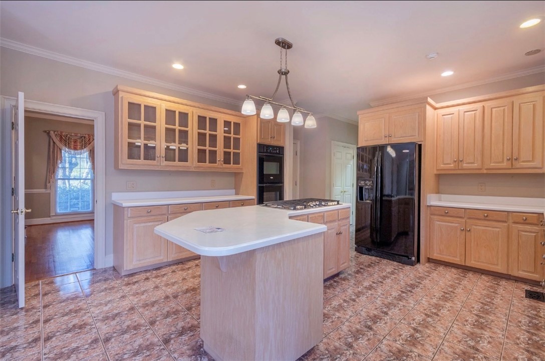 1104 Thornehill Drive Anderson, SC 29621 - Photo 21 of 35 This spacious kitchen offers a functional island and warm wood cabinetry, perfect for culinary endeavors.