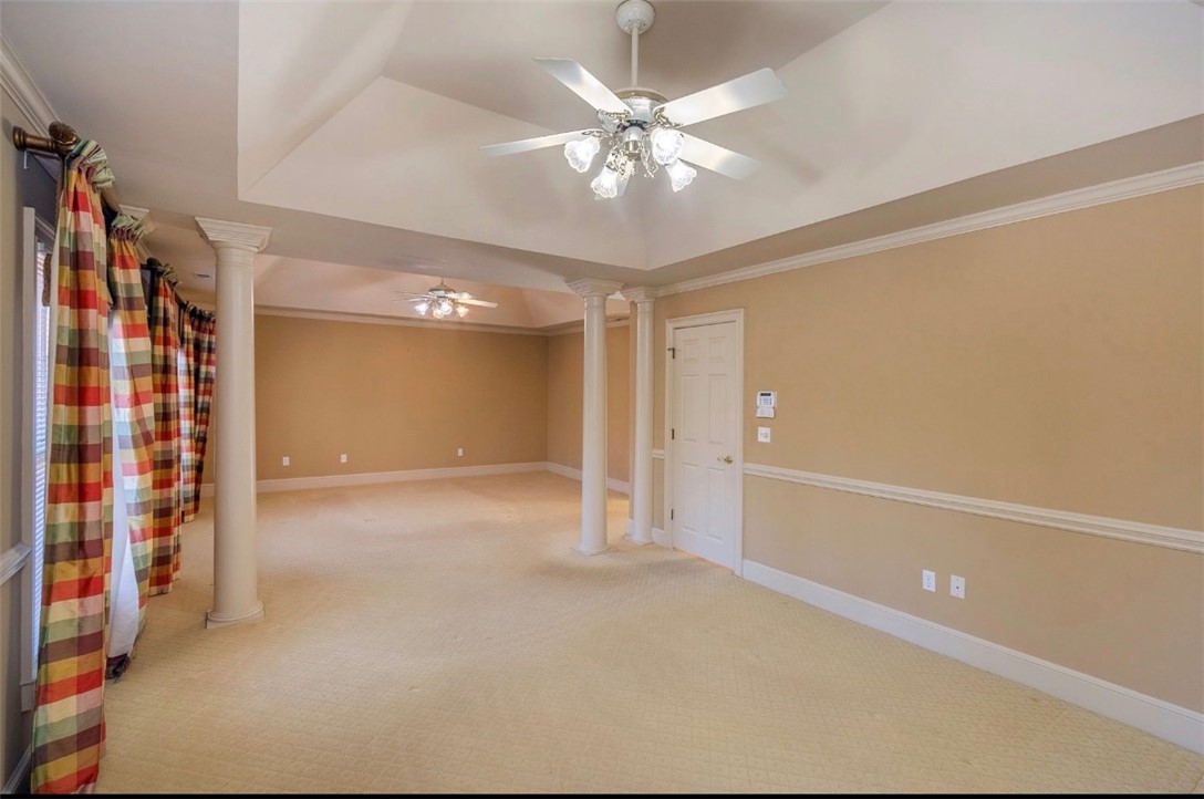 1104 Thornehill Drive Anderson, SC 29621 - Photo 29 of 35 This spacious room features vaulted ceilings, elegant columns, and carpeted flooring, creating an inviting atmosphere.
