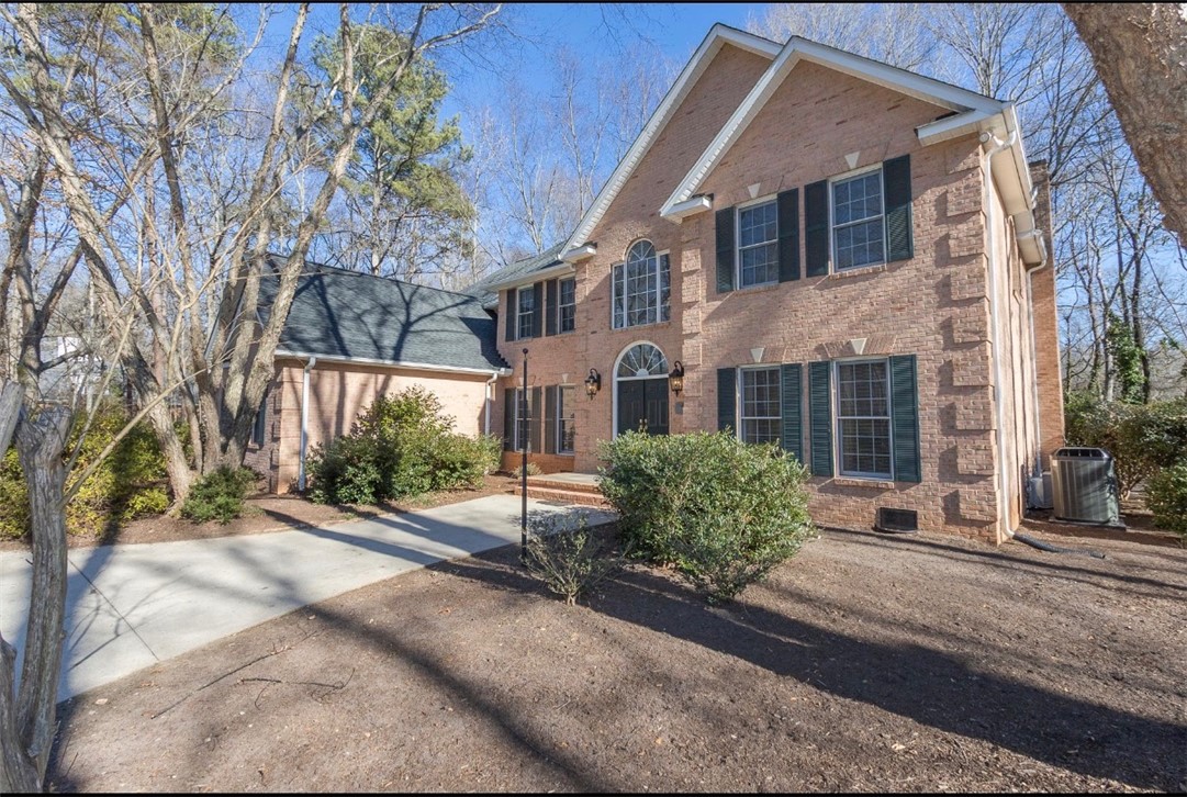 1104 Thornehill Drive Anderson, SC 29621 - Photo 3 of 35 This classic brick residence features an inviting facade with well-maintained landscaping and a spacious driveway.