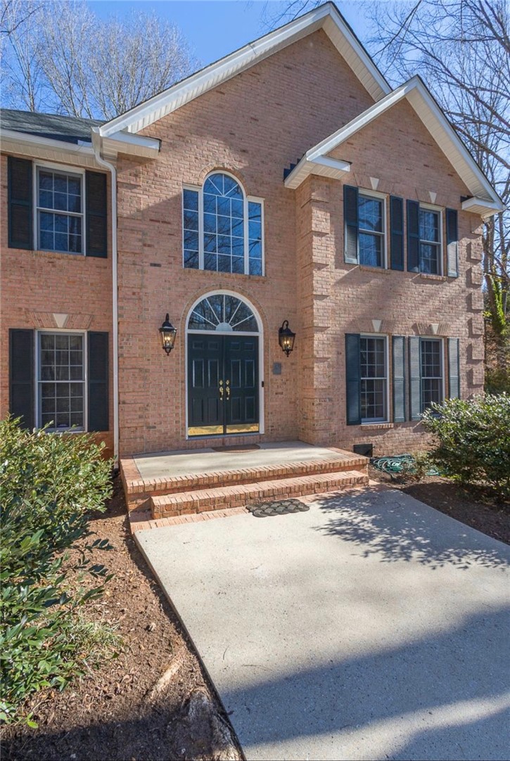 1104 Thornehill Drive Anderson, SC 29621 - Photo 4 of 35 This brick home offers a welcoming entrance with arched windows and a well-maintained exterior.