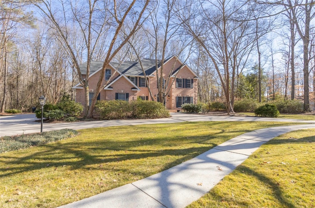 1104 Thornehill Drive Anderson, SC 29621 - Photo 6 of 35 This spacious brick residence boasts a welcoming facade with a well-maintained lawn.
