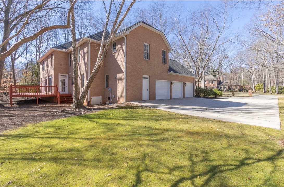 1104 Thornehill Drive Anderson, SC 29621 - Photo 9 of 35 This brick home offers a spacious deck and an expansive driveway leading to a multi-car garage.