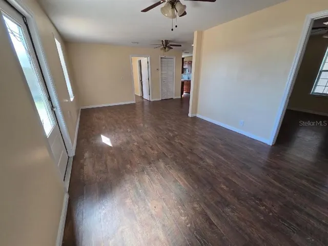 wooden floor in an empty room with a window