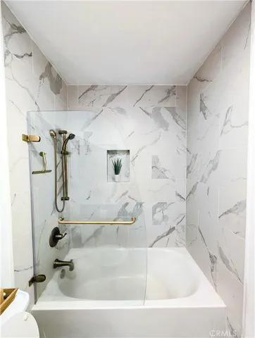 a spacious bathroom with a sink a toilet and a bathtub