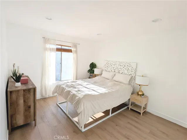 a bedroom with a bed and window