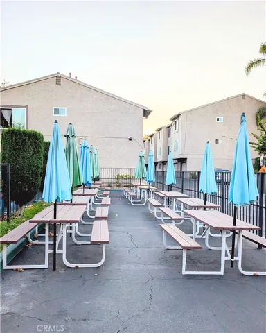 a view of a swimming pool with a slide and a fire pit