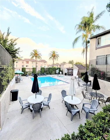 a view of a patio with a table and chairs under an umbrella