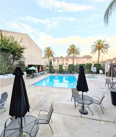 a view of swimming pool with outdoor seating and plants