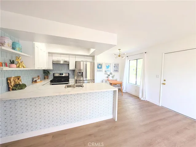 a living room with furniture and a kitchen view