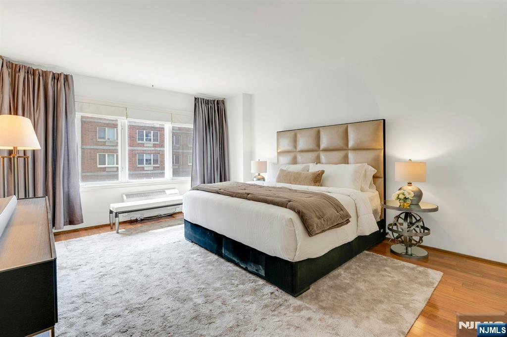 3219 City Place Edgewater, NJ 07020 - Photo 13 of 28 a bedroom with a bed and wooden floor
