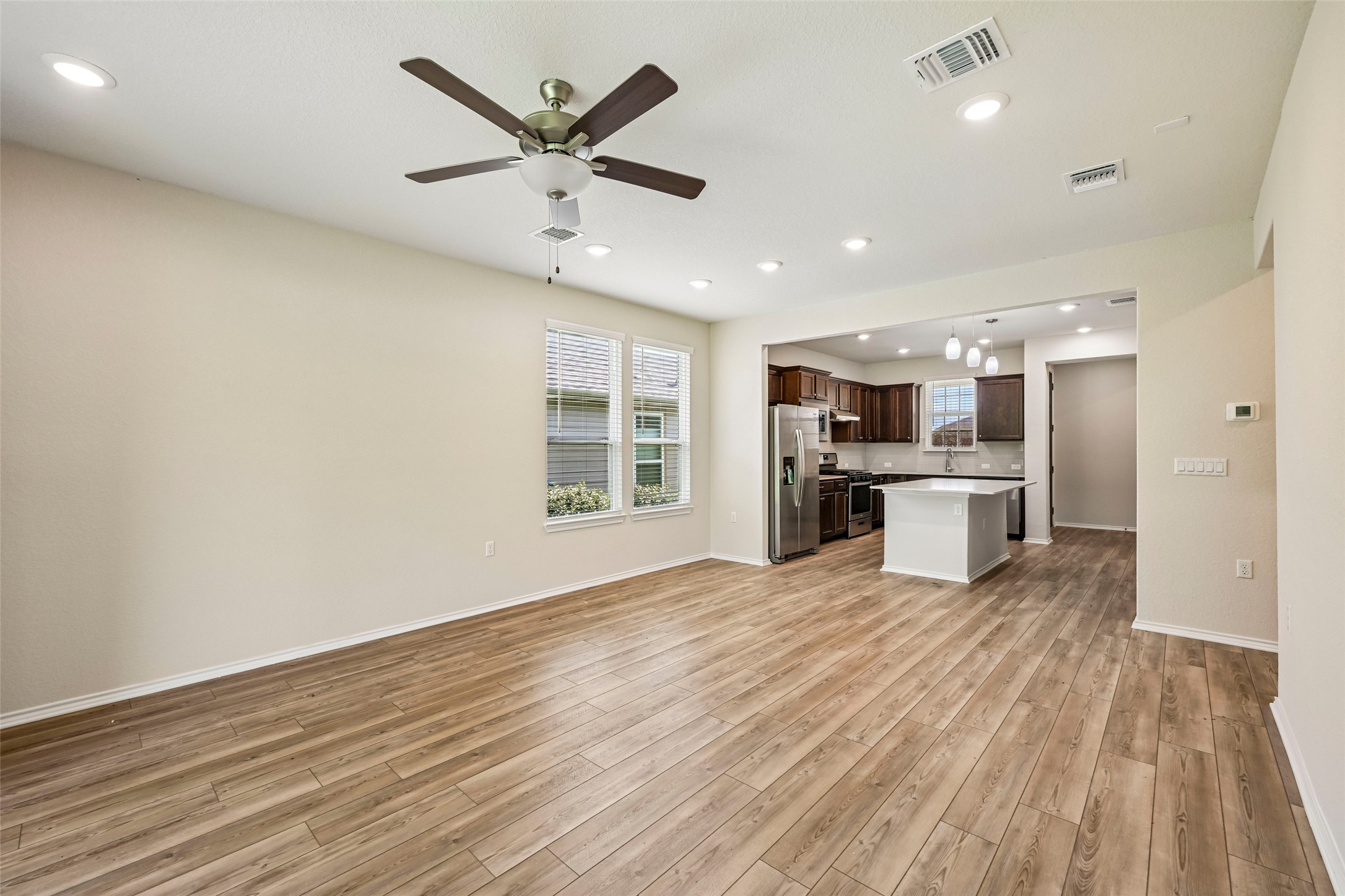 401 Yorktown Street Georgetown, TX 78633 - Photo 14 of 38 Open-concept living area with wood-finish flooring, recessed lighting, and a ceiling fan