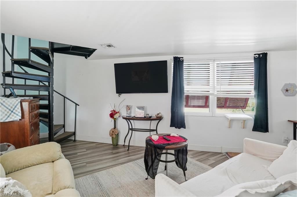 5431 Oak Ridge Avenue Fort Myers Beach, FL 33931 - Photo 13 of 33 a living room with furniture and a flat screen tv