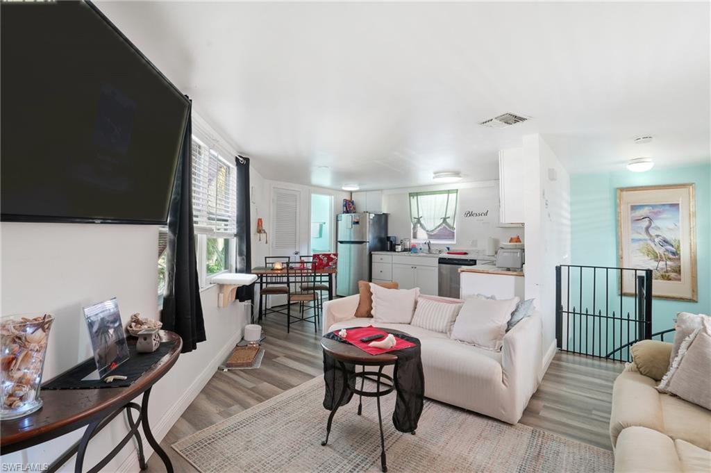 5431 Oak Ridge Avenue Fort Myers Beach, FL 33931 - Photo 14 of 33 a living room with furniture and a flat screen tv