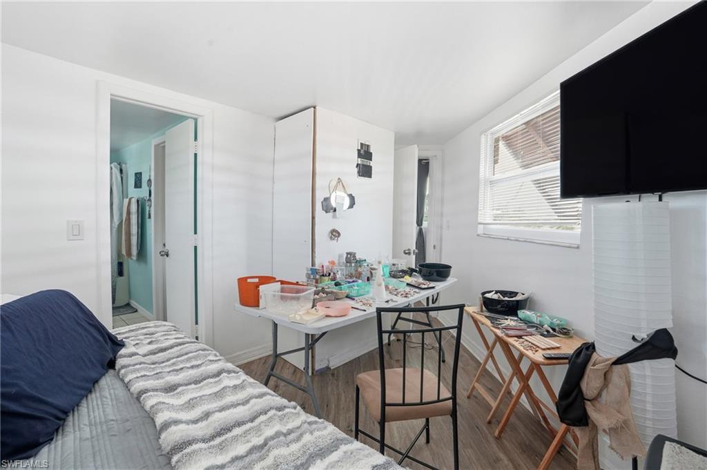 5431 Oak Ridge Avenue Fort Myers Beach, FL 33931 - Photo 20 of 33 a living room with furniture a flat screen tv and a window