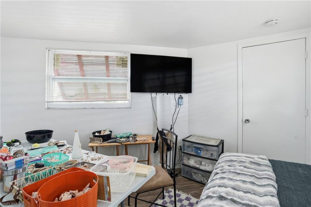 5431 Oak Ridge Avenue Fort Myers Beach, FL 33931 - Photo 21 of 33 a bedroom with a bed and a flat screen tv