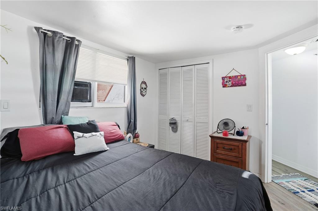 5431 Oak Ridge Avenue Fort Myers Beach, FL 33931 - Photo 25 of 33 a bedroom with a bed and a window