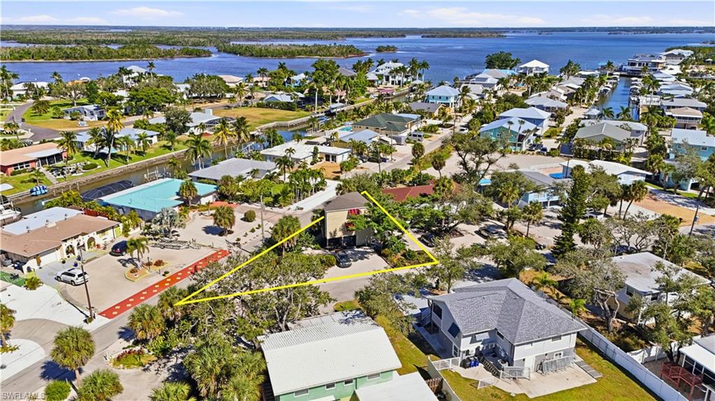 5431 Oak Ridge Avenue Fort Myers Beach, FL 33931 - Photo 3 of 33 an aerial view of a house with a lake view