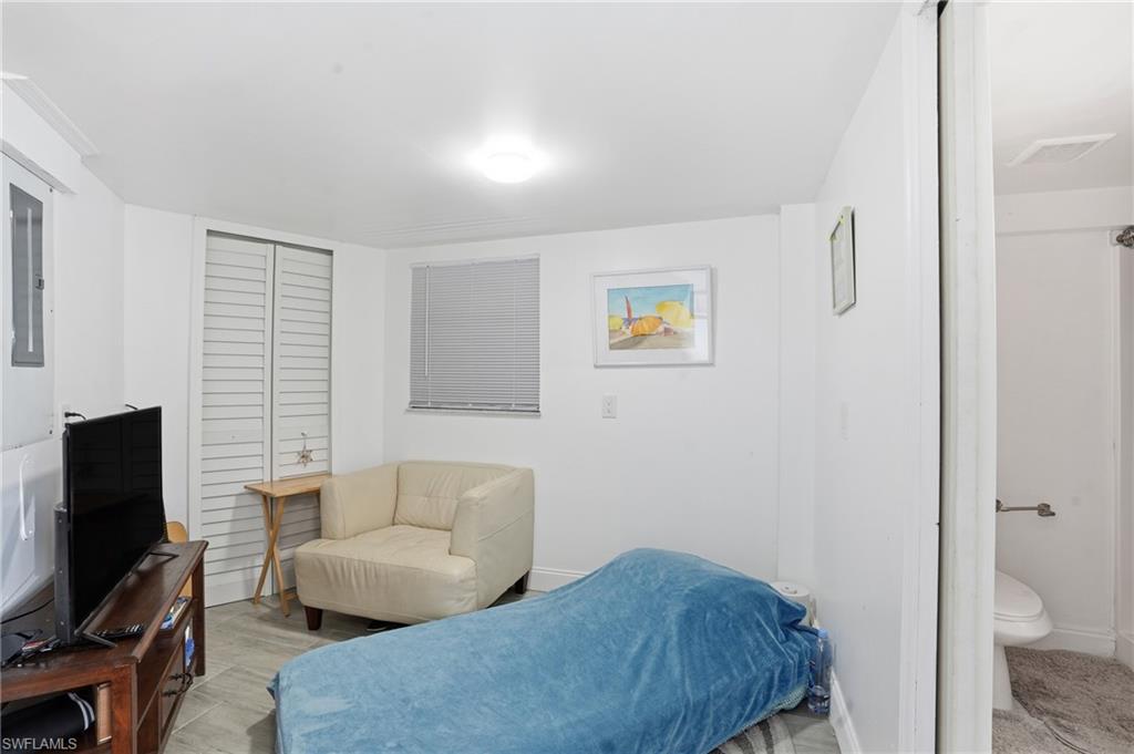 5431 Oak Ridge Avenue Fort Myers Beach, FL 33931 - Photo 10 of 33 a living room with furniture and a flat screen tv