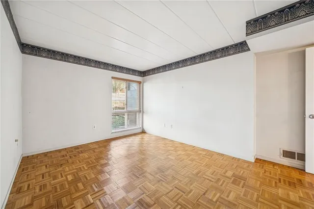 a view of an empty room with a window