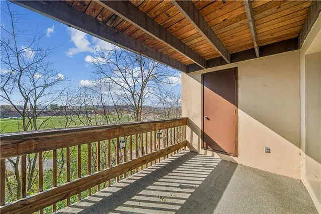 a view of a balcony with wooden floor