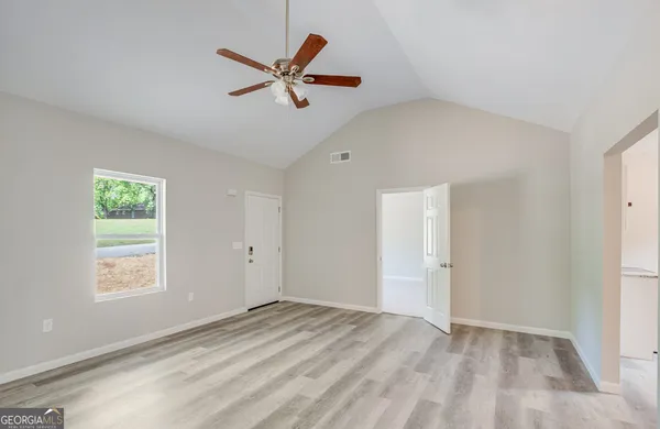 a view of a livingroom with a ceiling fan and window