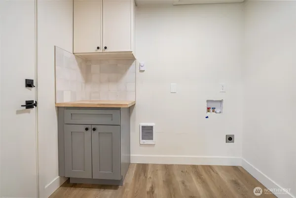 a view of storage and utility room with wooden floor