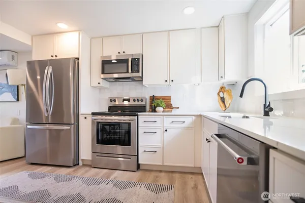 a kitchen with a refrigerator stove and sink