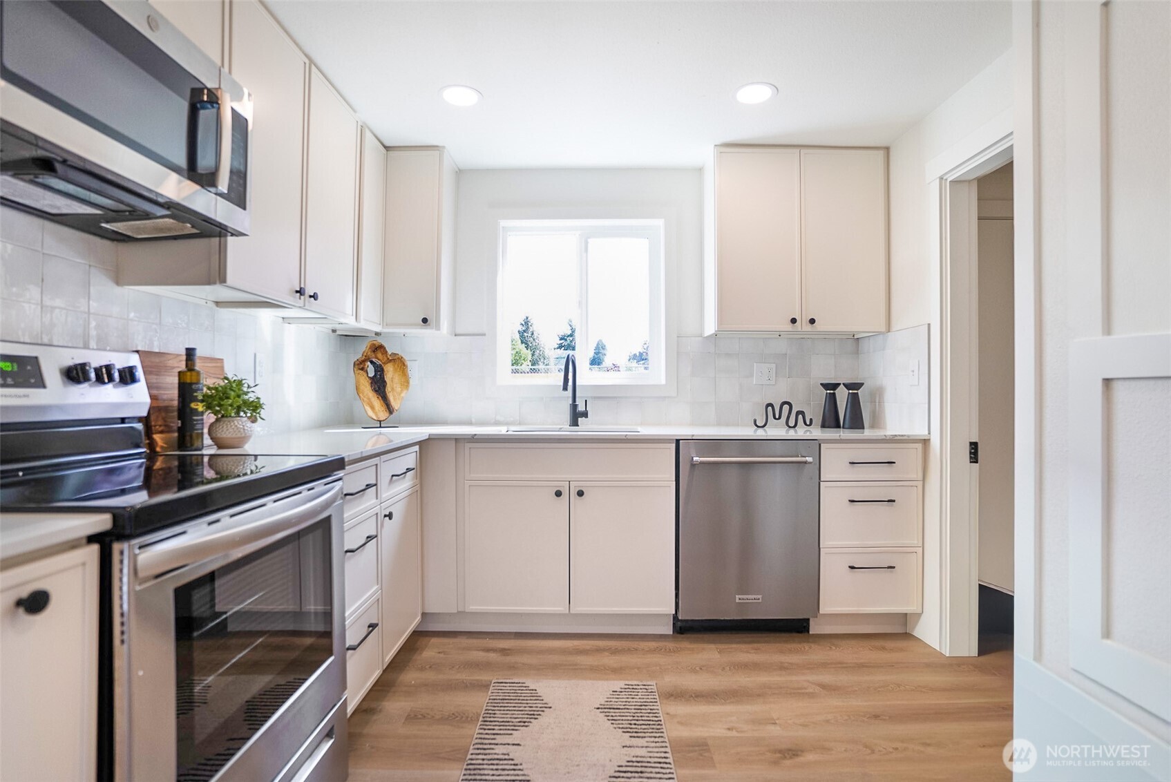 7934 20th Avenue Southwest Seattle, WA 98106 - Photo 7 of 20 a kitchen with white cabinets and white appliances