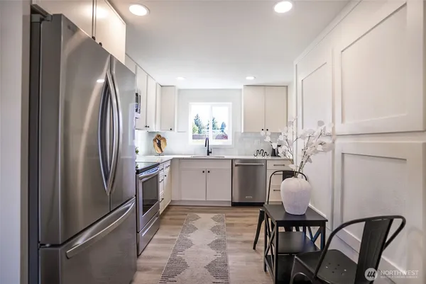 a kitchen with a refrigerator and a sink