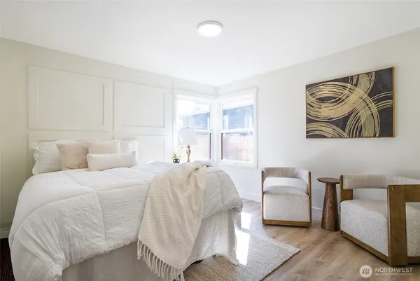 a spacious bedroom with a bed and a couch