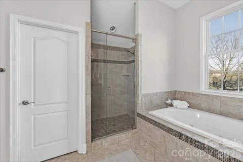 a bathroom with a granite countertop bathtub shower sink and toilet