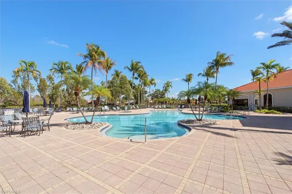 a view of a swimming pool with an outdoor space and seating area