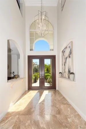 a view of a living room with a large window and chandelier