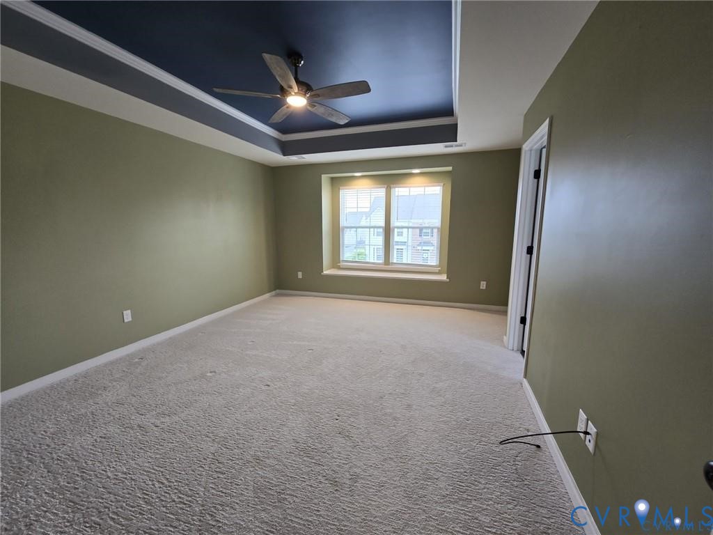 7825 Old Guild Road Richmond, VA 23237 - Photo 18 of 27 Spacious room with a tray ceiling featuring a dark