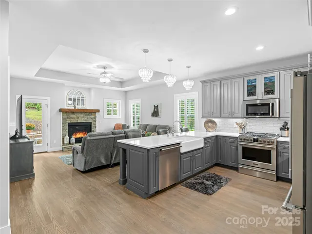 a kitchen with kitchen island wooden cabinets and stainless steel appliances