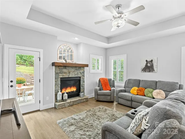 a view of a dining room with furniture wooden floor and a fireplace