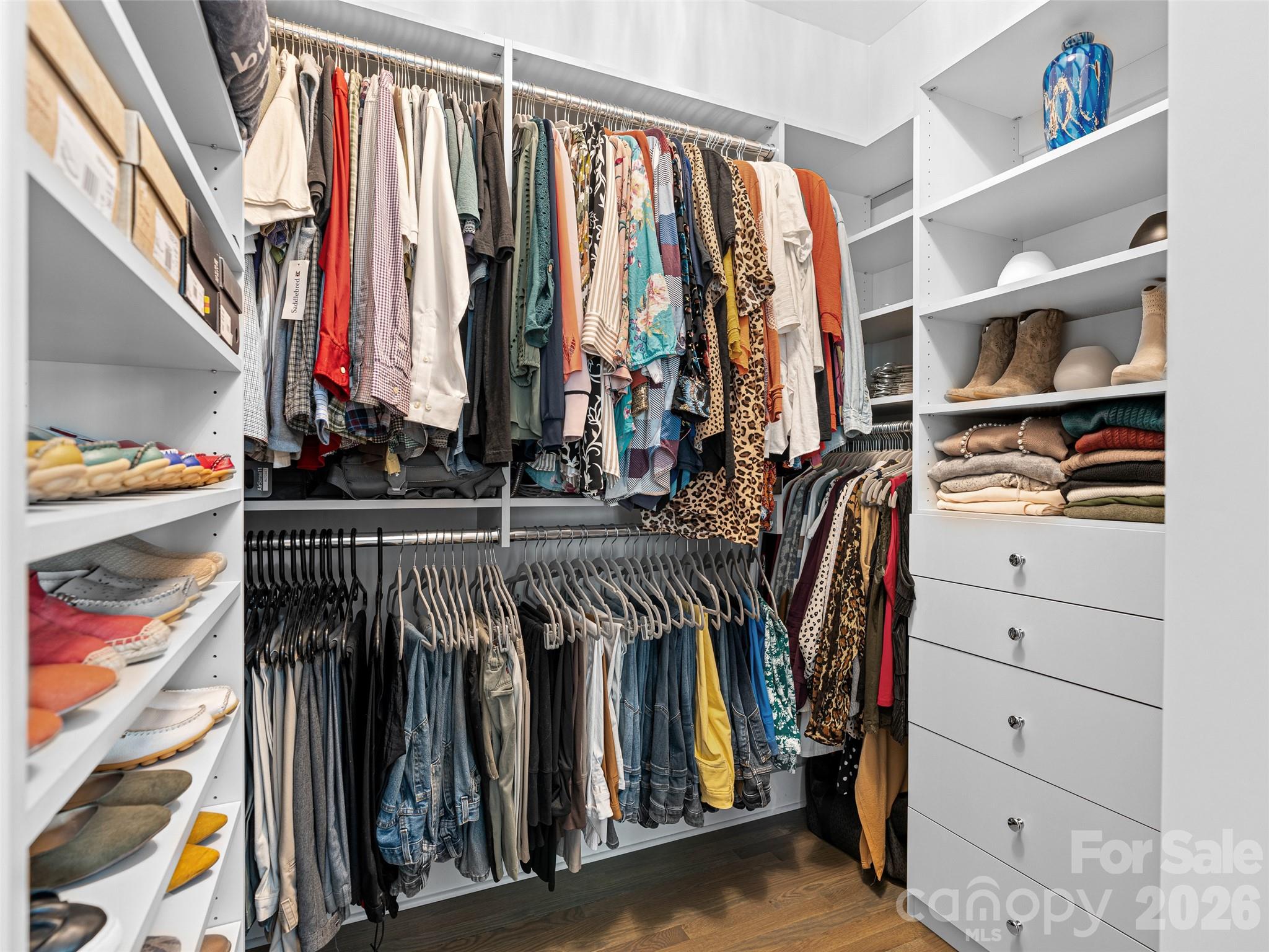 139 Clay Street Fairview, NC 28730 - Photo 23 of 35 a view of walk in closet with clothes and shoes