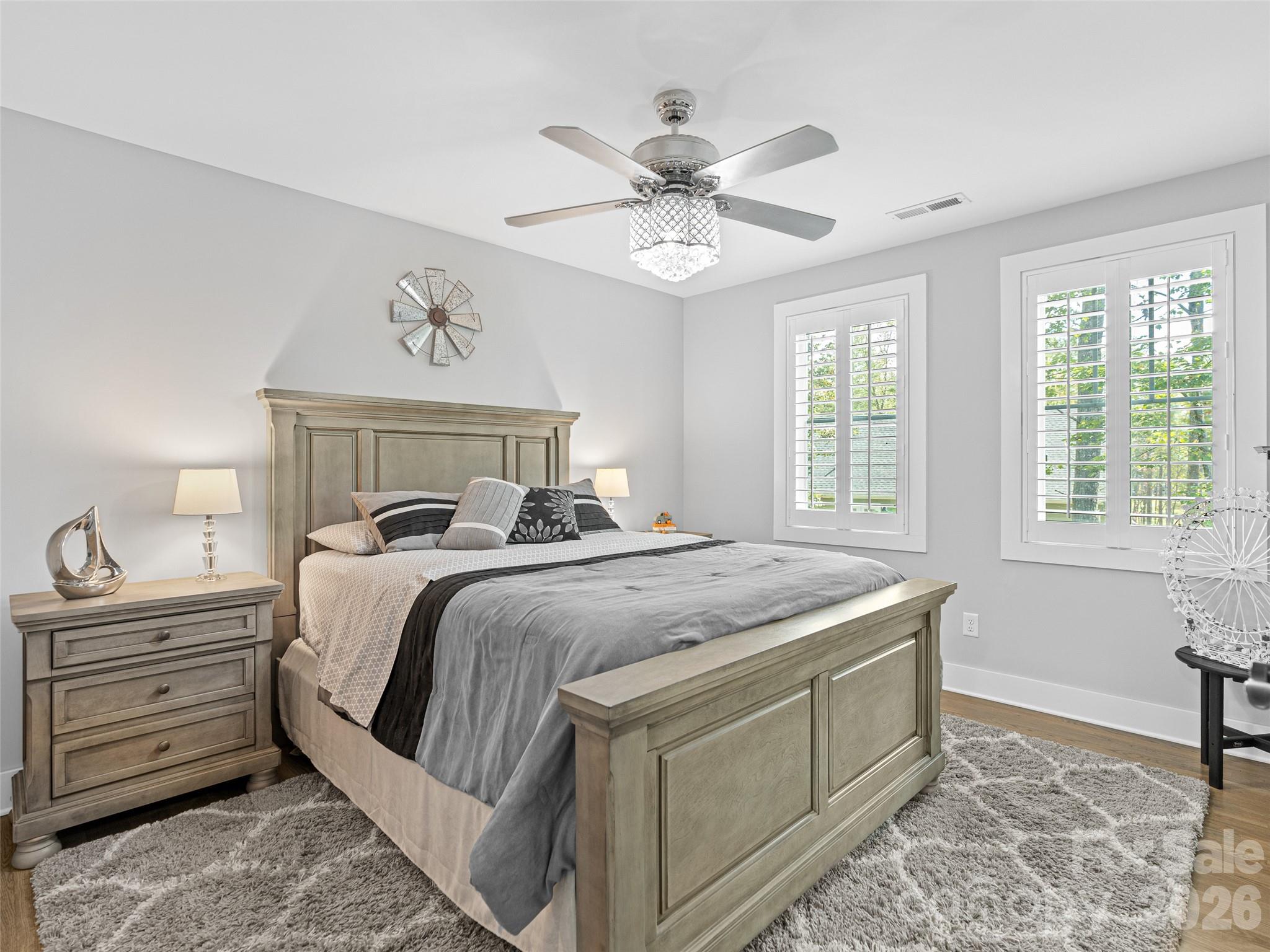 139 Clay Street Fairview, NC 28730 - Photo 28 of 35 a bedroom with a bed and a chandelier