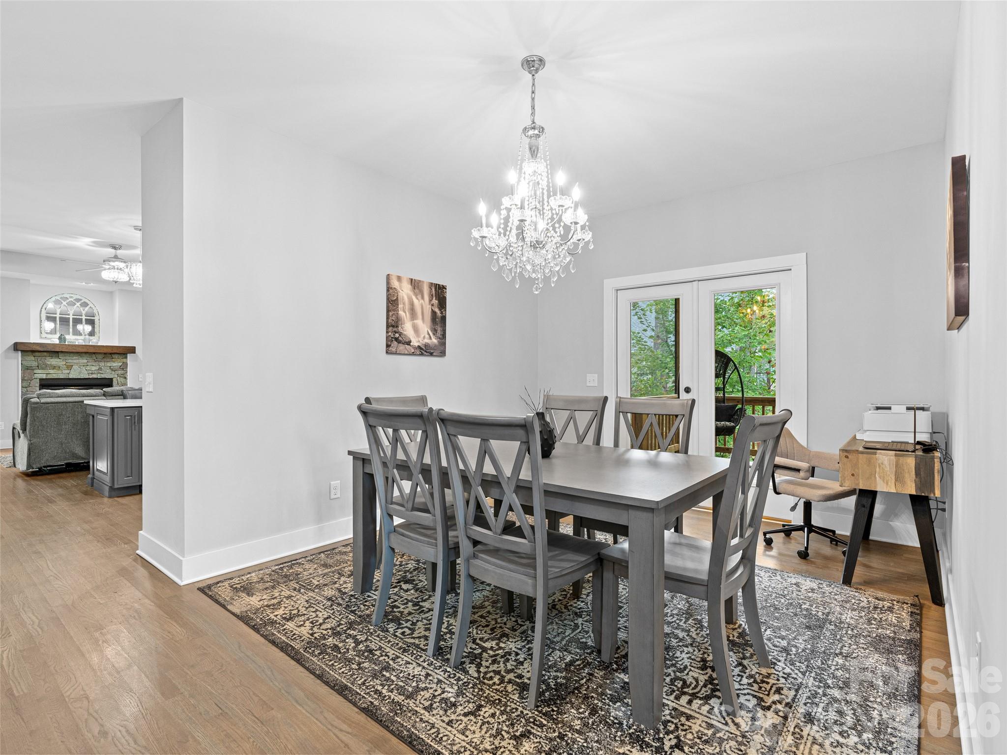 139 Clay Street Fairview, NC 28730 - Photo 7 of 35 a dining room with furniture a rug and a chandelier