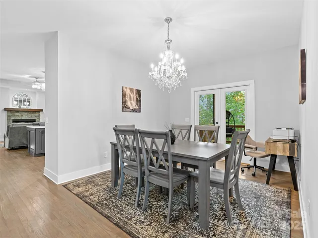 a dining room with furniture a rug and a chandelier