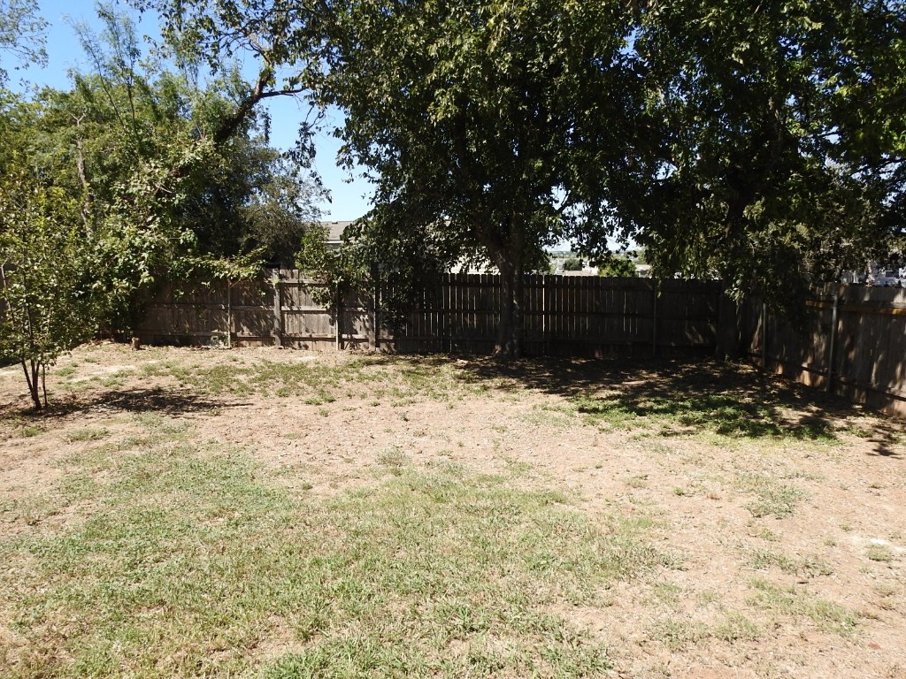 571 New Country Road Kyle, TX 78640 - Photo 18 of 21 a view of a yard covered in snow