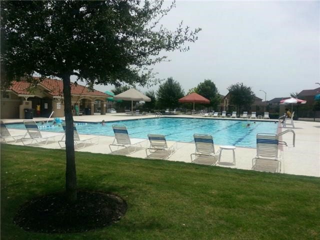 571 New Country Road Kyle, TX 78640 - Photo 21 of 21 a view of a lake with a garden and swimming pool