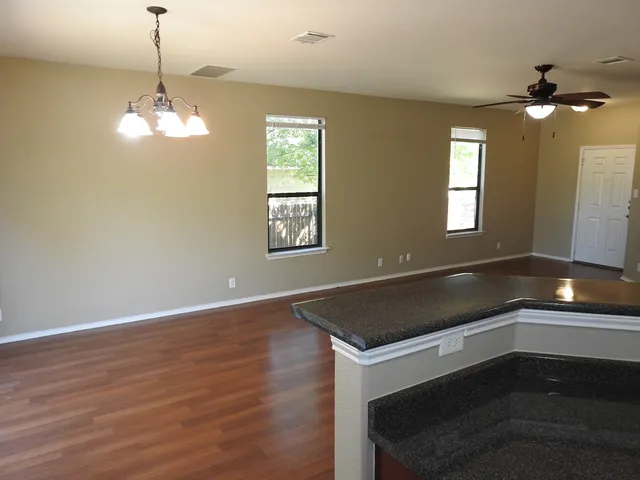 a kitchen with a refrigerator and chandelier