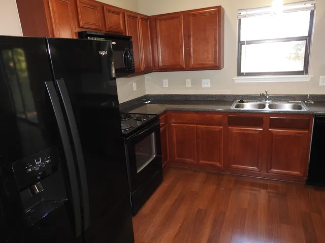 a kitchen with a sink stove and refrigerator