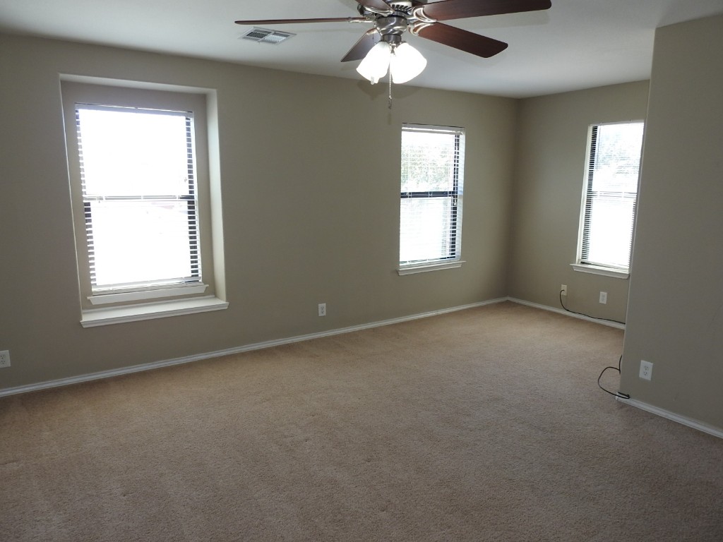 571 New Country Road Kyle, TX 78640 - Photo 10 of 21 an empty room with a window and a fan